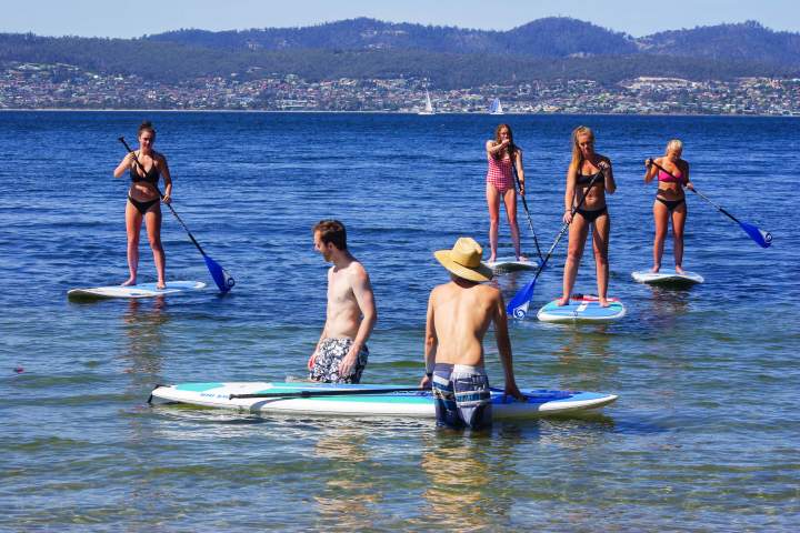 Paddleboarding women and men