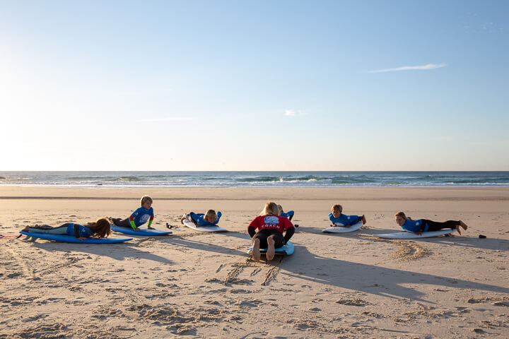 Surf groms lesson on the beach
